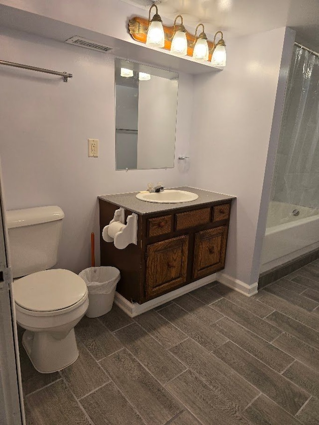 full bathroom with shower / tub combo, vanity, hardwood / wood-style flooring, and toilet