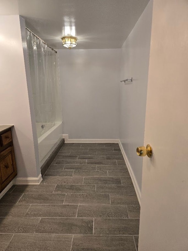 bathroom with hardwood / wood-style floors, vanity, and shower / bath combination with curtain