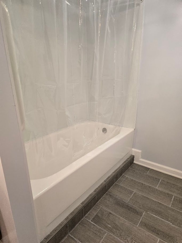 bathroom with shower / bath combination with curtain