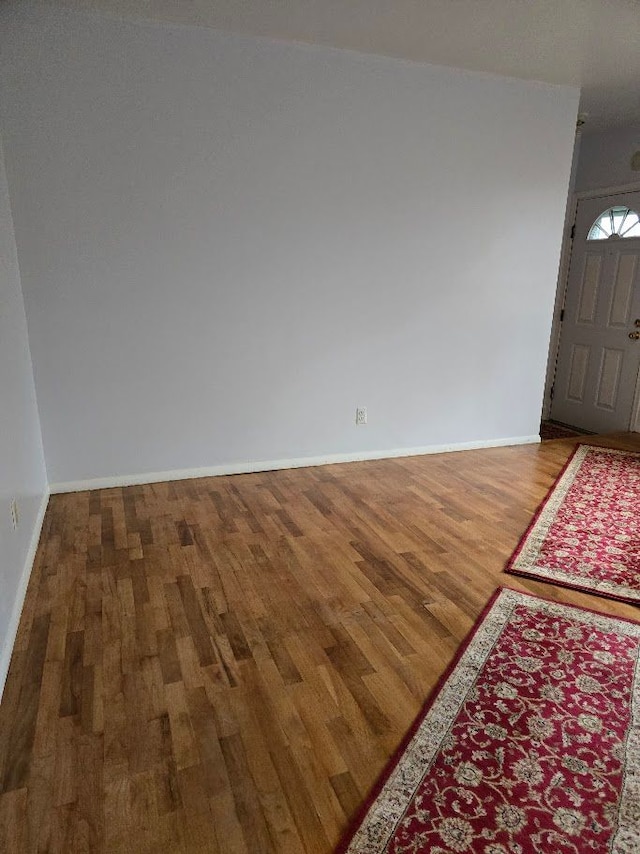 empty room with hardwood / wood-style flooring