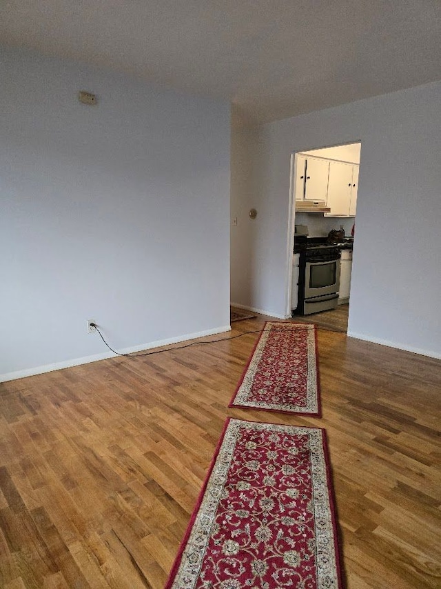 unfurnished living room featuring hardwood / wood-style flooring and a textured ceiling