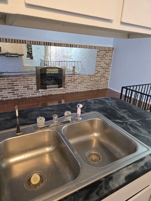 interior details featuring white cabinetry and sink