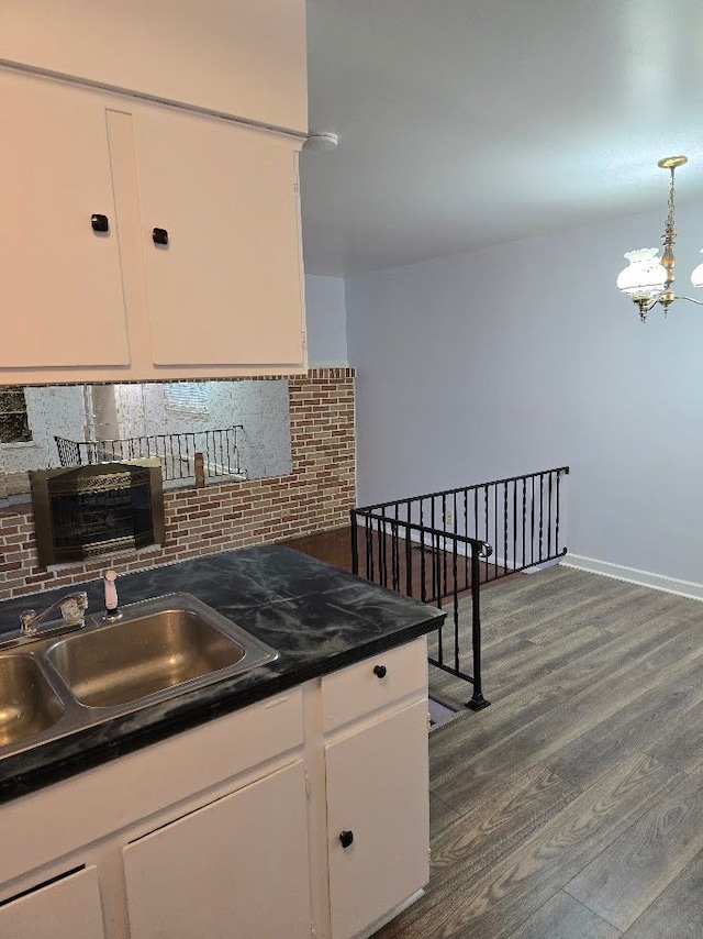 kitchen with decorative backsplash, white cabinetry, sink, and dark wood-type flooring