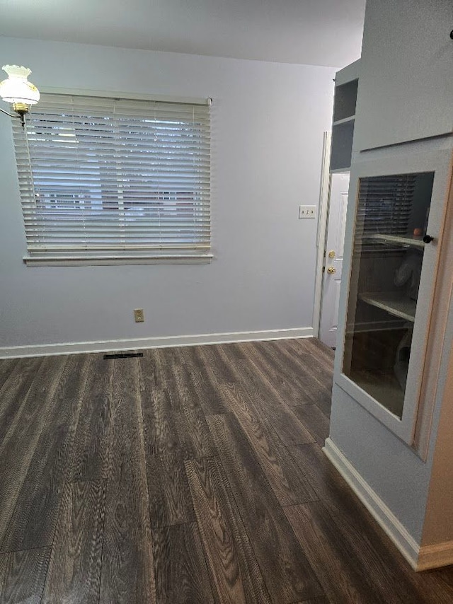 spare room featuring dark hardwood / wood-style flooring