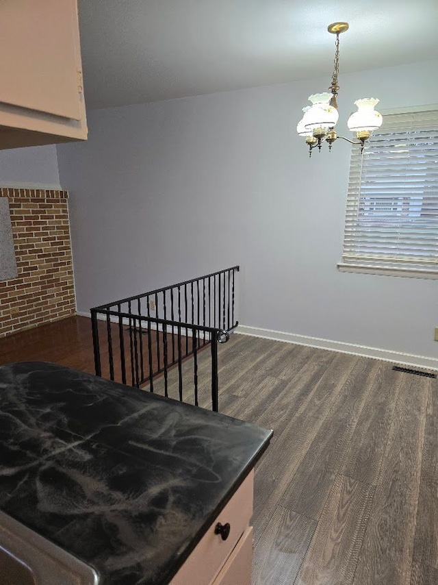 interior space with hardwood / wood-style floors and a notable chandelier