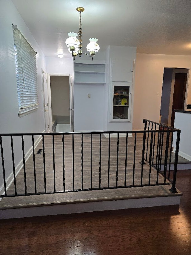 interior space featuring dark hardwood / wood-style flooring and an inviting chandelier