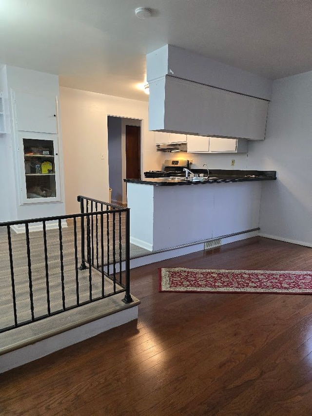 kitchen with white cabinets and dark hardwood / wood-style floors