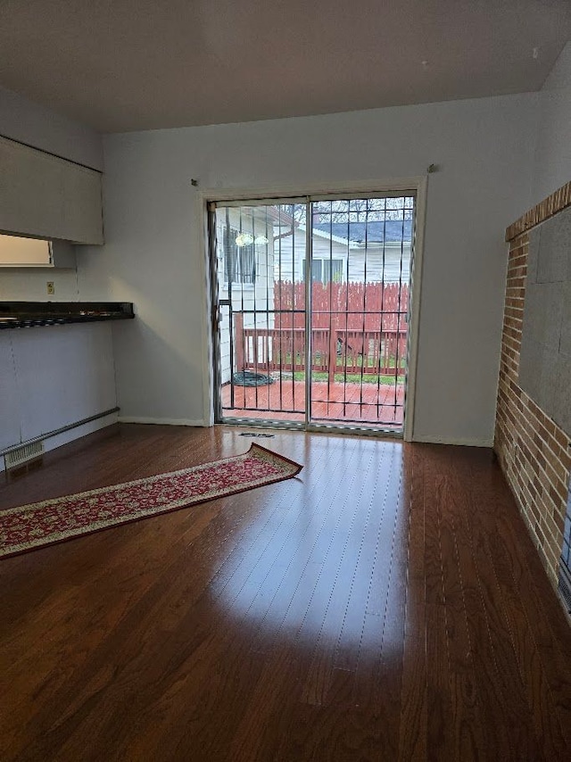 unfurnished living room featuring hardwood / wood-style flooring and a fireplace