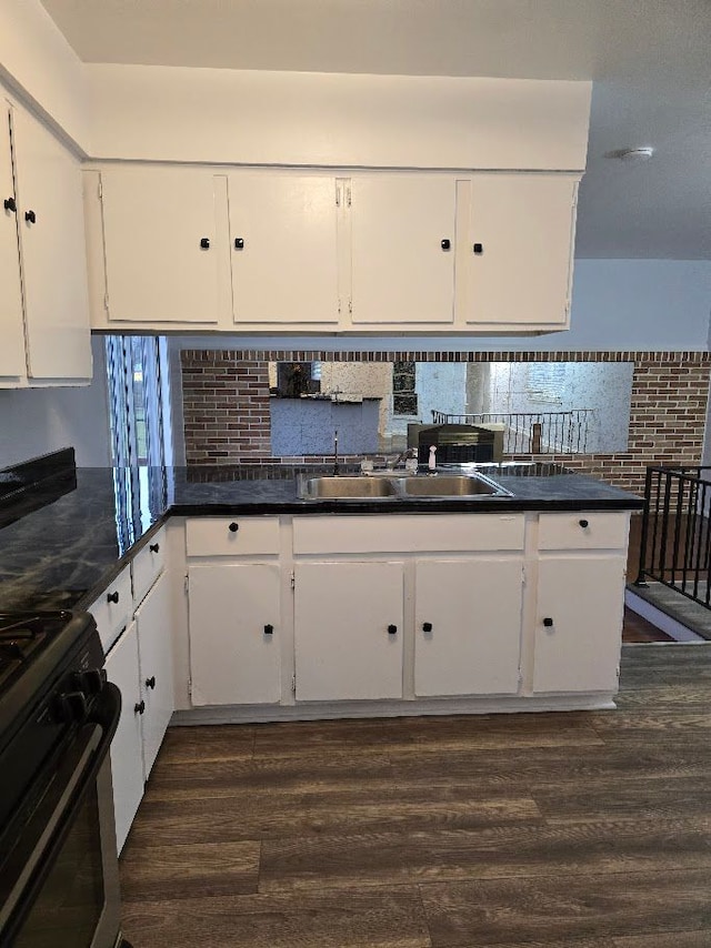 kitchen featuring white cabinets, dark hardwood / wood-style flooring, and black range with gas cooktop