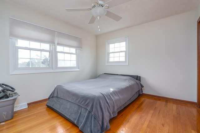 bedroom with ceiling fan and light hardwood / wood-style floors