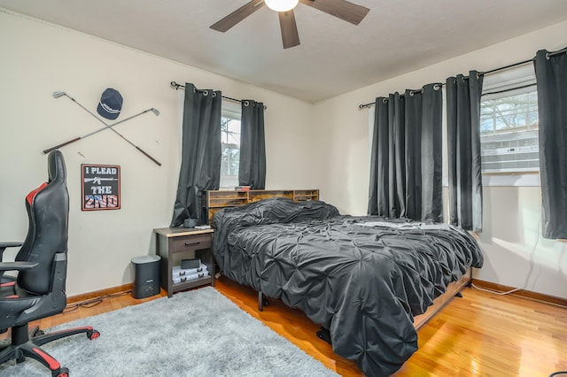 bedroom with ceiling fan and light hardwood / wood-style floors