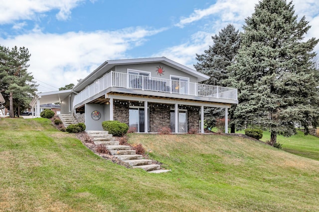 view of front of home with a wooden deck and a front lawn