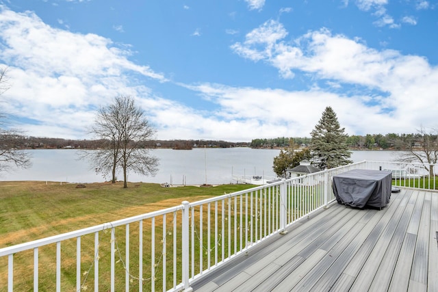 wooden terrace featuring a water view and a yard