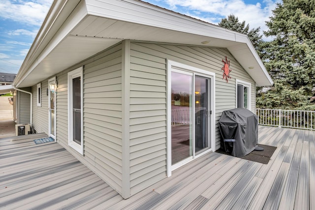 wooden deck with a grill