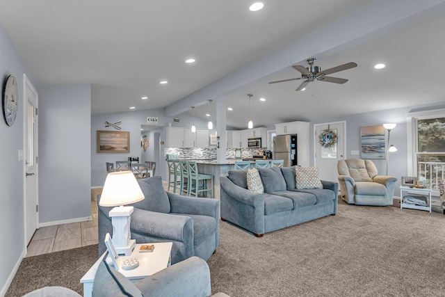 living room featuring vaulted ceiling with beams, light colored carpet, and ceiling fan