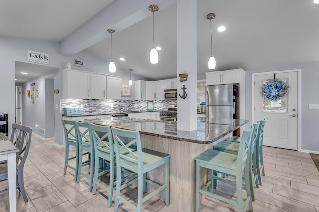 kitchen featuring vaulted ceiling with beams, dark stone countertops, white cabinets, backsplash, and stainless steel appliances