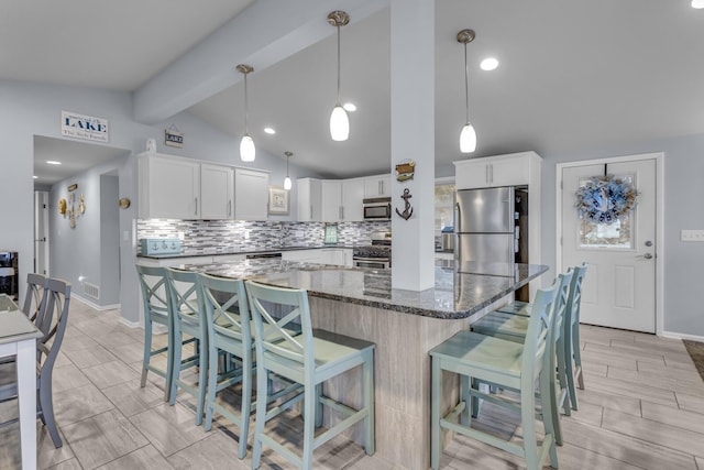 11767 Greenbriar Dr, Jerome, MI 49249 - kitchen with appliances with stainless steel finishes, decorative backsplash, a breakfast bar, and dark stone countertops