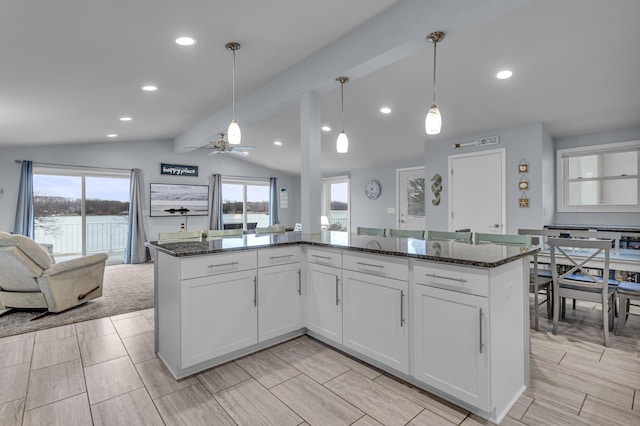 11767 Greenbriar Dr, Jerome, MI 49249 - kitchen with open floor plan, dark stone countertops, ceiling fan, white cabinets, and recessed lighting