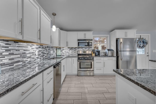 11767 Greenbriar Dr, Jerome, MI 49249 - kitchen featuring stainless steel appliances, a sink, tasteful backsplash, and white cabinetry