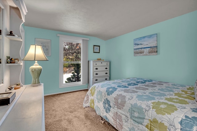 bedroom featuring vaulted ceiling and carpet flooring