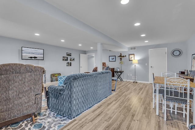 11767 Greenbriar Dr, Jerome, MI 49249 - living area featuring wood finished floors, baseboards, and recessed lighting