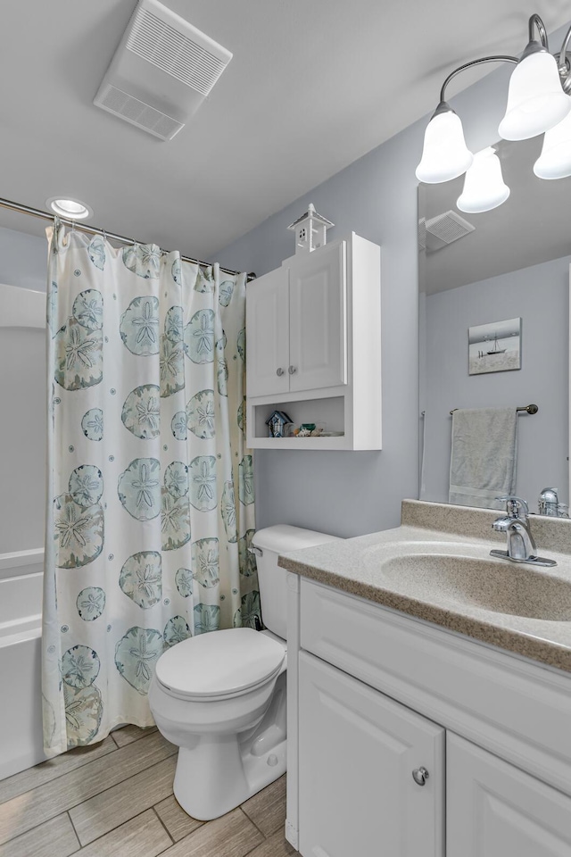 11767 Greenbriar Dr, Jerome, MI 49249 - full bathroom featuring vanity, toilet, wood finished floors, and a shower with shower curtain