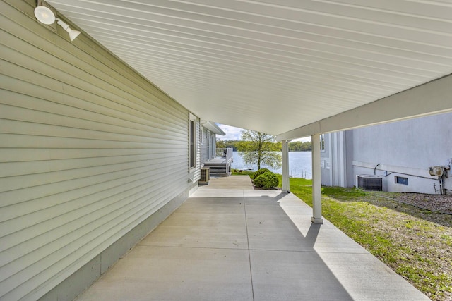 11767 Greenbriar Dr, Jerome, MI 49249 - view of patio featuring a water view and cooling unit