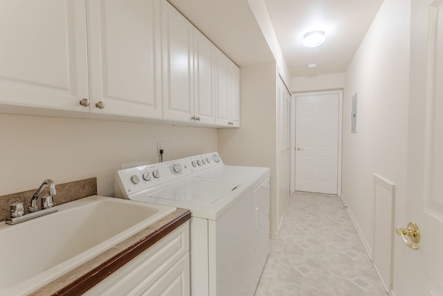 laundry area featuring cabinets, washer and clothes dryer, sink, light tile patterned floors, and electric panel