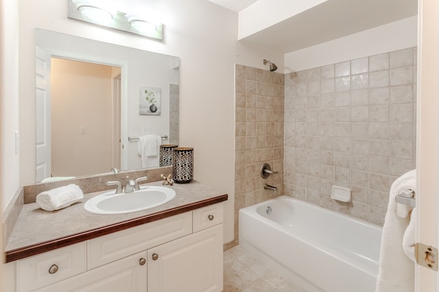 bathroom with vanity and tiled shower / bath