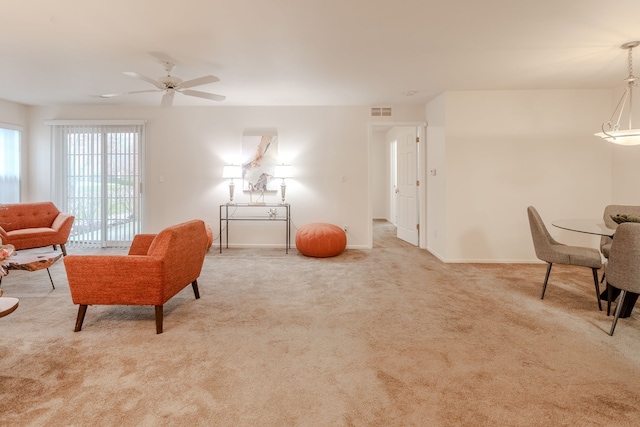 living room featuring light carpet and ceiling fan