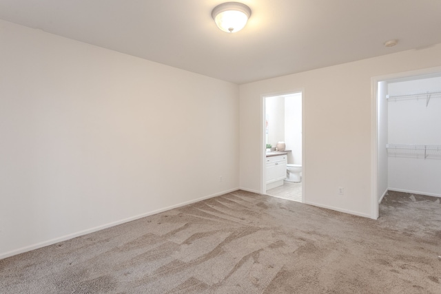 spare room featuring light carpet