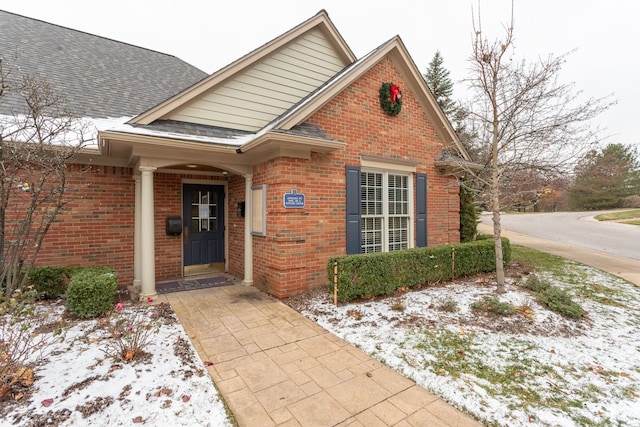 view of snow covered property entrance