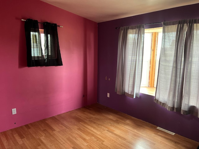 empty room with hardwood / wood-style floors