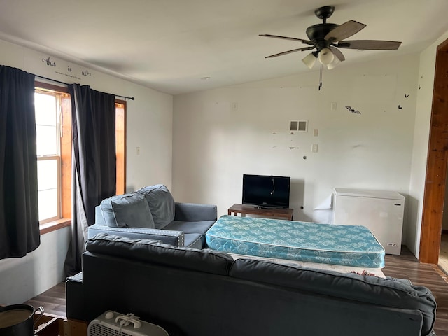 living room with dark hardwood / wood-style floors, vaulted ceiling, and ceiling fan