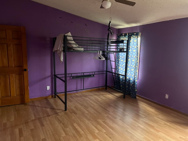 unfurnished bedroom with hardwood / wood-style floors and a textured ceiling