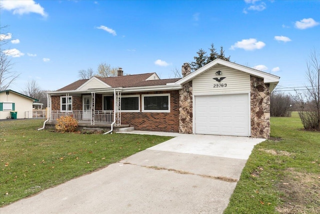 ranch-style home with a garage, driveway, a front lawn, and covered porch