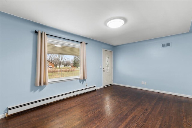 unfurnished room featuring a baseboard radiator, visible vents, dark wood finished floors, and baseboards