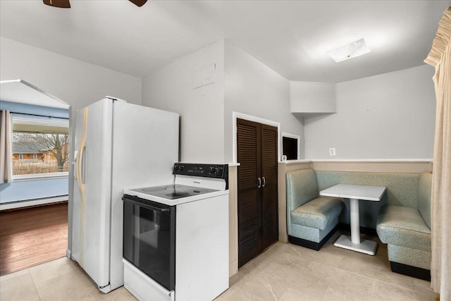 kitchen featuring white appliances and a baseboard radiator