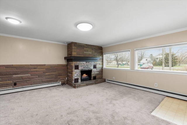 unfurnished living room with ornamental molding, a baseboard radiator, carpet flooring, and a fireplace