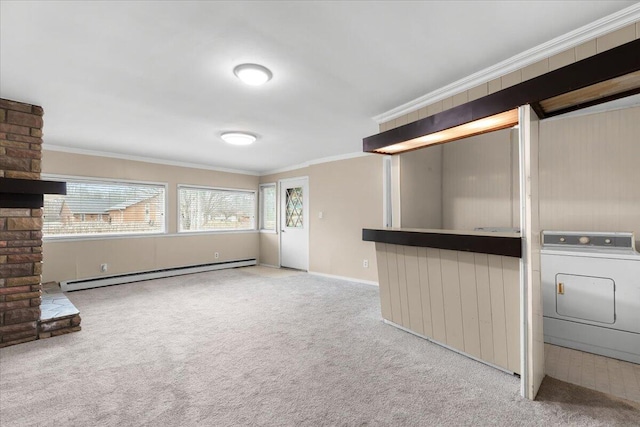 unfurnished living room with washer / dryer, a baseboard radiator, ornamental molding, and carpet floors