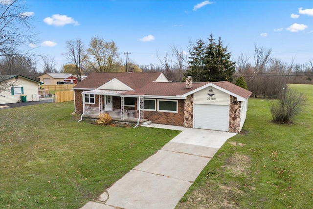 view of front of property featuring an attached garage, covered porch, fence, driveway, and a front lawn