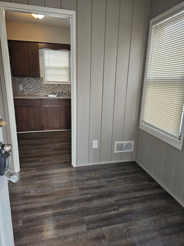 unfurnished bedroom featuring dark hardwood / wood-style floors and sink