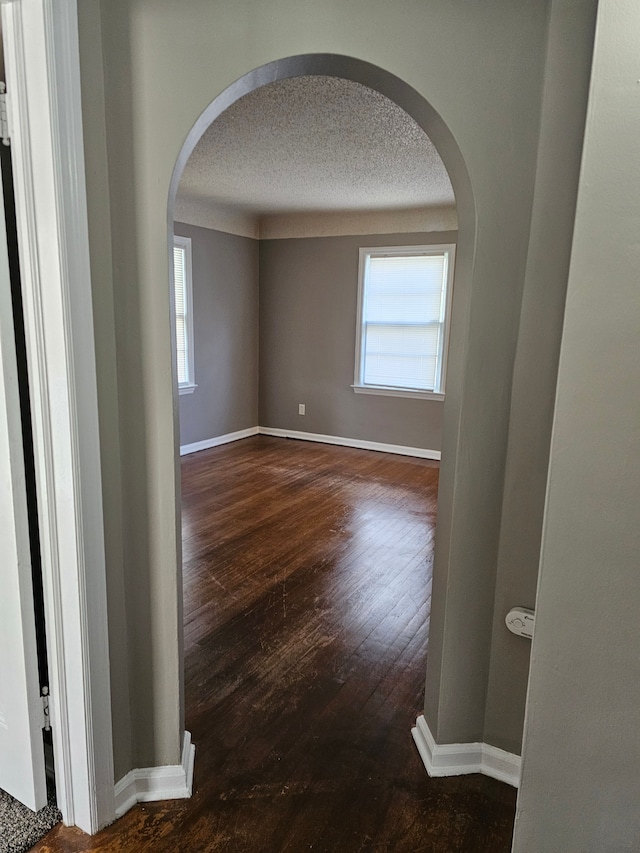 interior space with dark hardwood / wood-style flooring and a textured ceiling