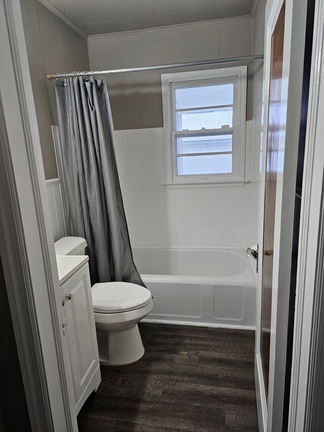 full bathroom featuring shower / bath combo, toilet, hardwood / wood-style flooring, vanity, and ornamental molding