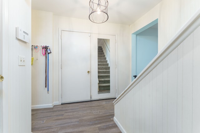 entryway featuring hardwood / wood-style floors and wood walls