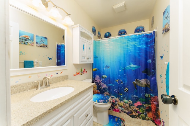 bathroom with toilet, tile patterned flooring, curtained shower, and vanity