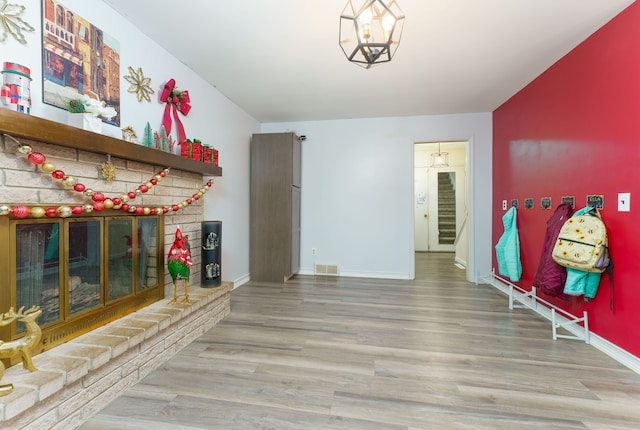 interior space featuring a fireplace, hardwood / wood-style floors, and an inviting chandelier