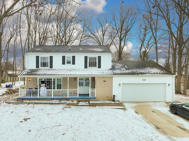 view of front of house featuring covered porch and a garage