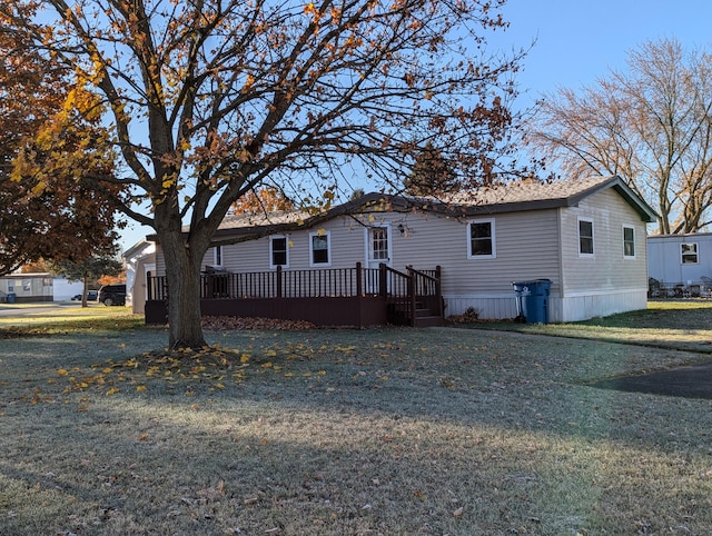 view of front of house featuring a front yard and a wooden deck