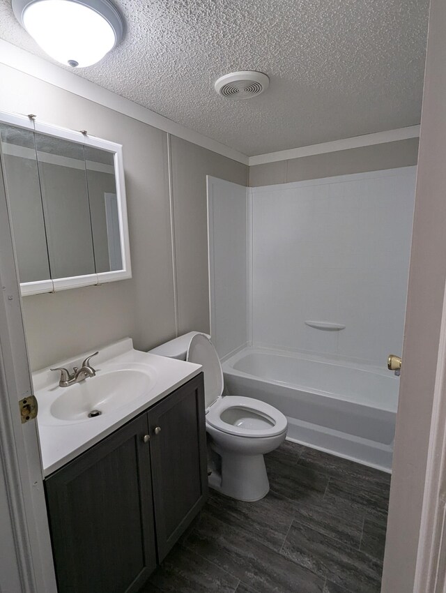 3683 Chestnut St, Clarkston, MI 48348 - full bathroom featuring a textured ceiling, vanity, toilet, and washtub / shower combination